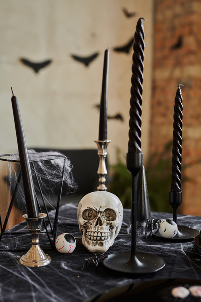 Halloween Decorations are on Table with Black Tablecloth